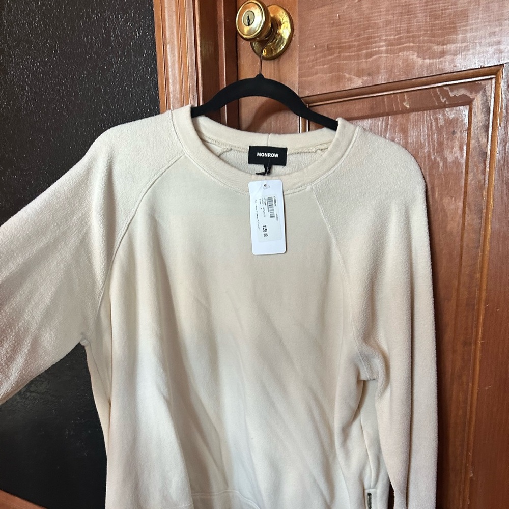 Sweatshirt, fleece  style sleeve with zippers on the ends